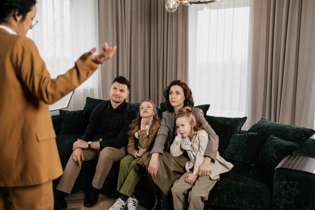 A family meeting with a youth coach   in a cozy living room, discussing home buying options.